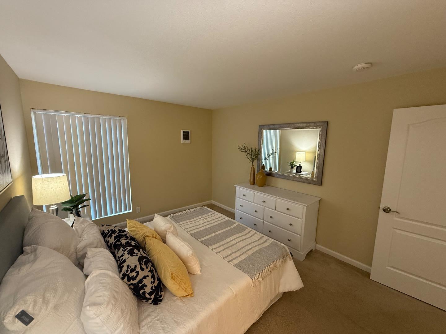 496 Dempsey Road, Unit 199 Milpitas, CA 95035 - Photo 21 of 41 a bedroom with a bed and a mirror
