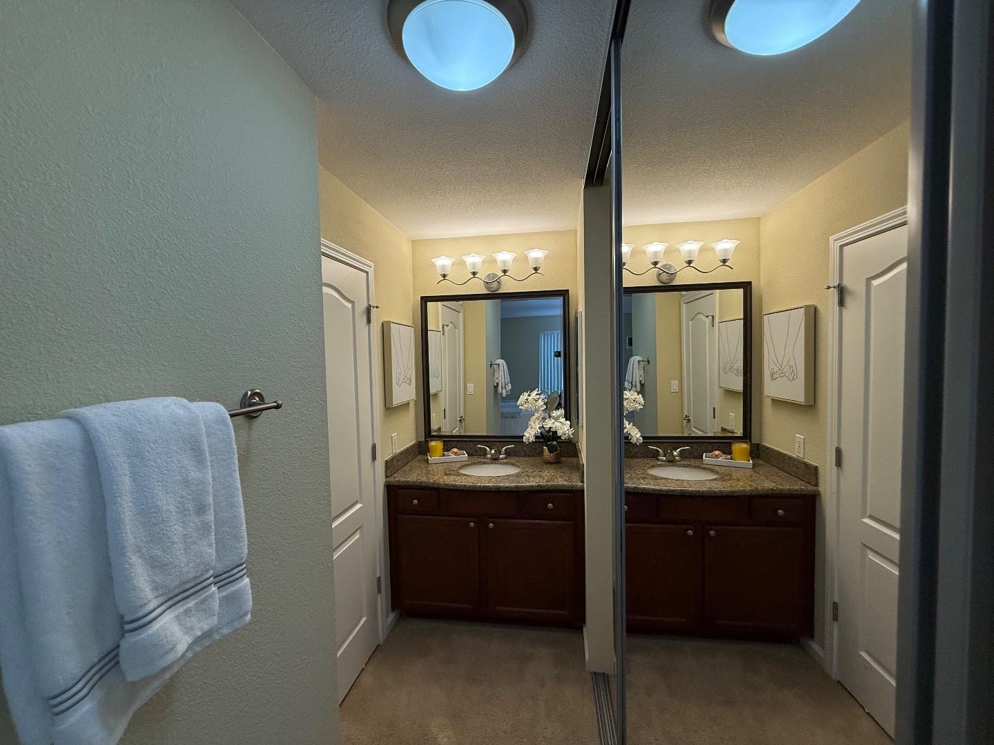 496 Dempsey Road, Unit 199 Milpitas, CA 95035 - Photo 25 of 41 a bathroom with a double vanity sink and mirror