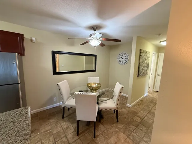 a dining room with furniture and a chandelier