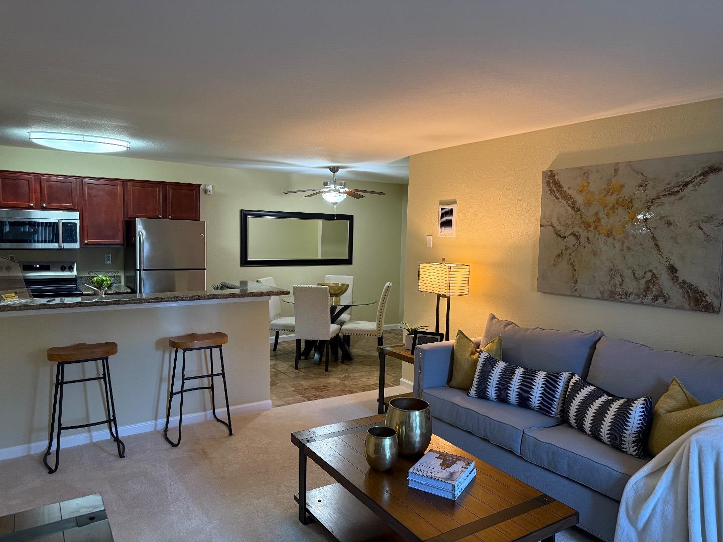 496 Dempsey Road, Unit 199 Milpitas, CA 95035 - Photo 9 of 41 a living room with fireplace furniture and a flat screen tv