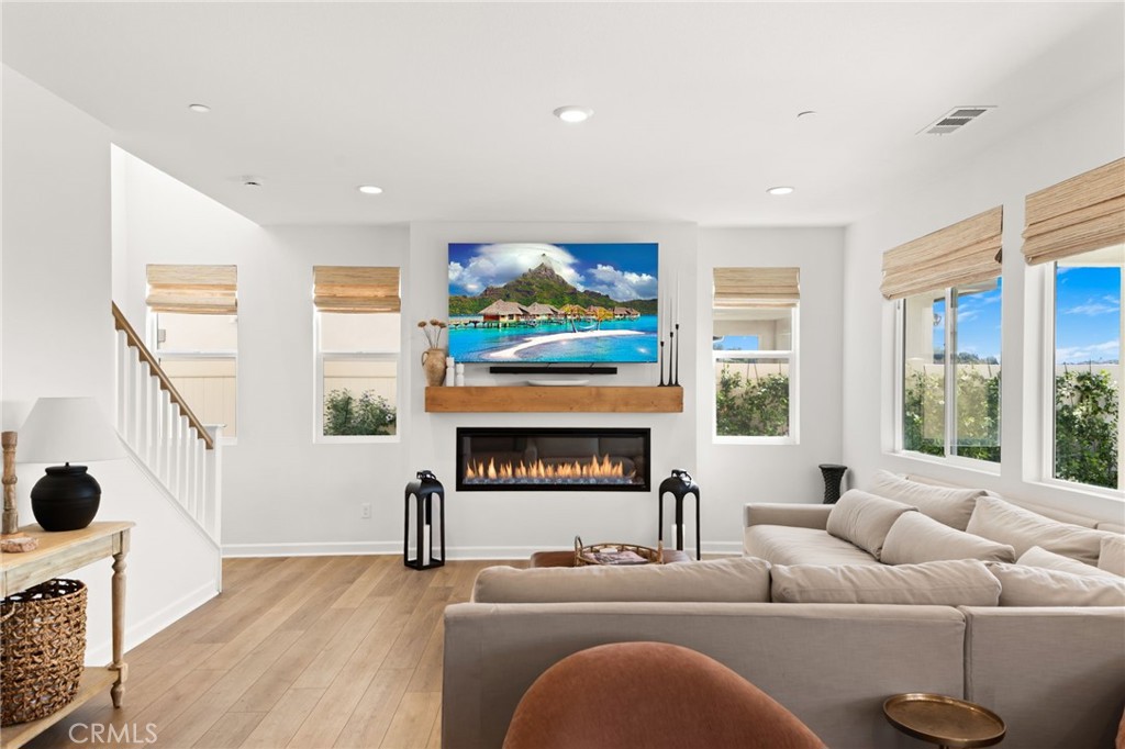 32259 Hillstone Street Temecula, CA 92591 - Photo 15 of 62 a living room with furniture a fireplace and a large window