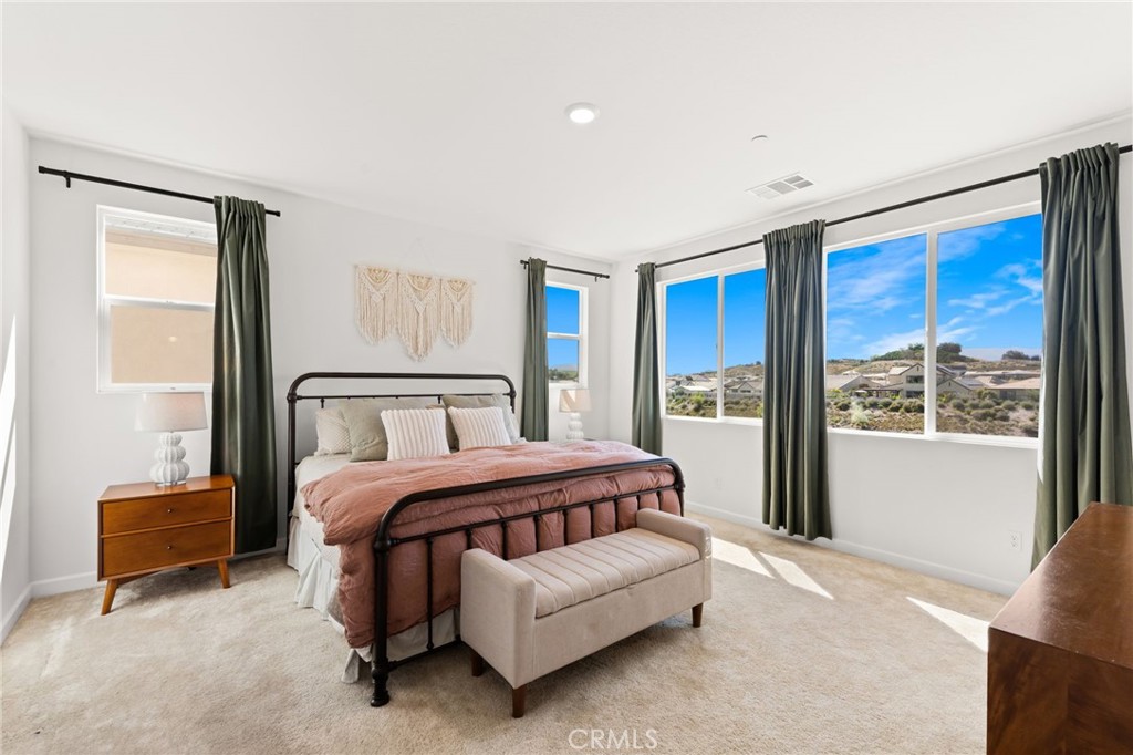 32259 Hillstone Street Temecula, CA 92591 - Photo 22 of 62 a spacious bedroom with a bed and a large window