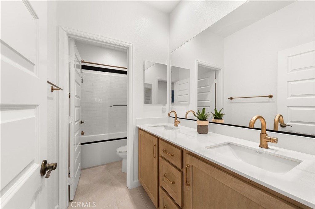 32259 Hillstone Street Temecula, CA 92591 - Photo 31 of 62 a bathroom with a double vanity sink mirror and double