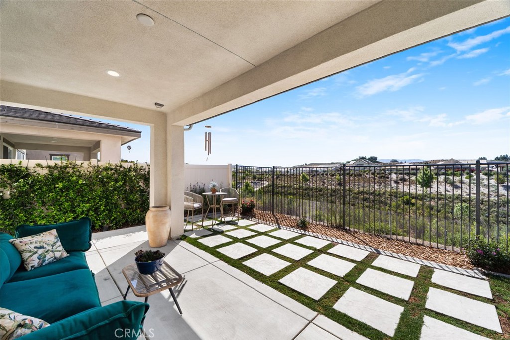 32259 Hillstone Street Temecula, CA 92591 - Photo 33 of 62 a view of a balcony with dining table and chairs with wooden floor
