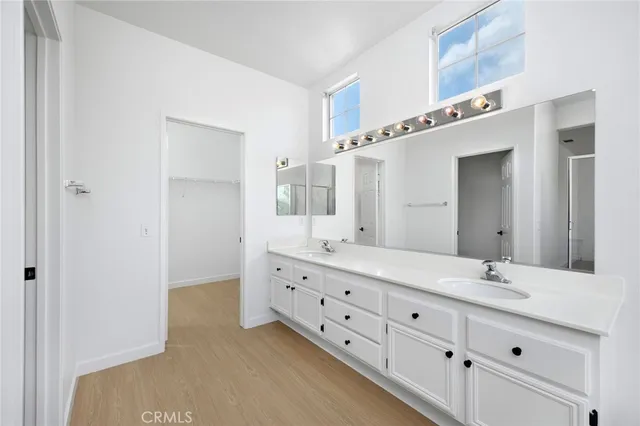 a bathroom with a double vanity sink and mirror