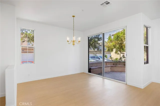 a view of empty room with wooden floor and outdoor view