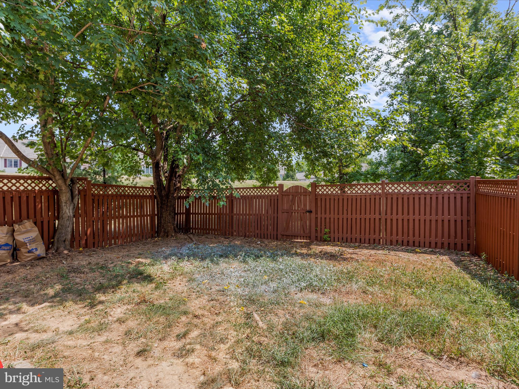 930 Mosby Drive Frederick, MD 21701 - Photo 46 of 52 a view of a backyard with wooden fence and a large tree