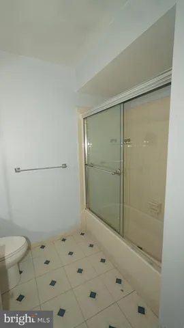 a bathroom with a shower toilet and sink