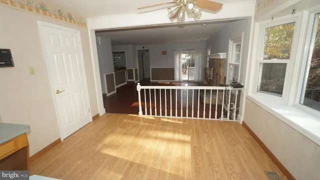 a view of a room with wooden floor and windows