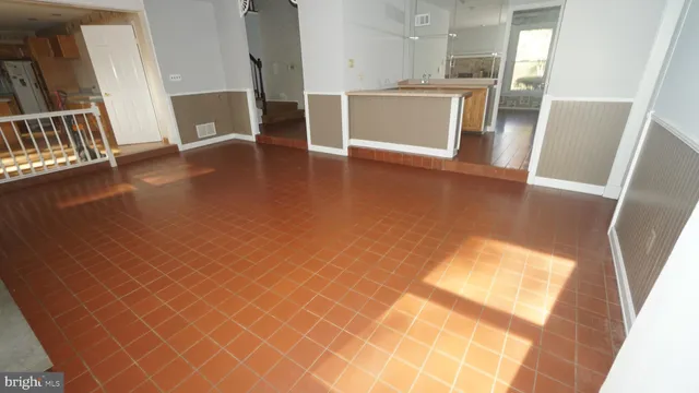 a view of a kitchen with furniture and wooden floor