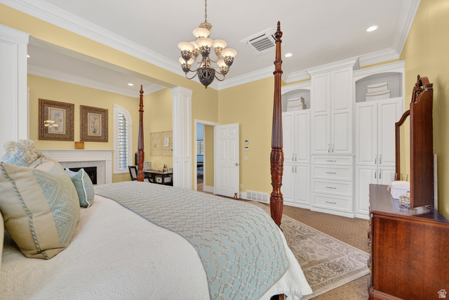 714 Draper Heights Way Draper, UT 84020 - Photo 29 of 88 Bedroom with carpet flooring, a fireplace, hanging lights, decorative columns, and crown molding