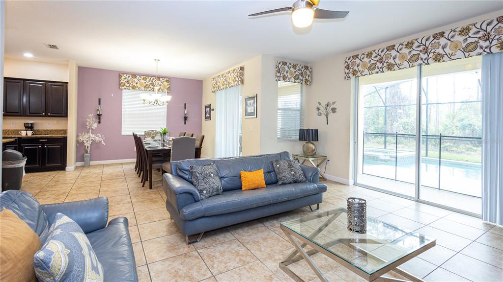 2977 Buccaneer Palm Road Kissimmee, FL 34747 - Photo 13 of 66 a living room with furniture and a flat screen tv