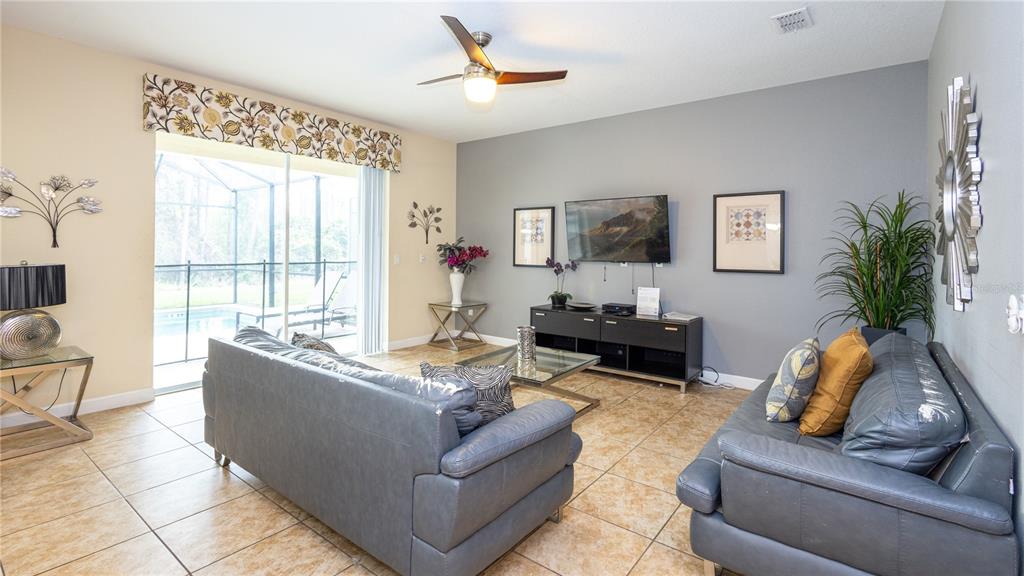 2977 Buccaneer Palm Road Kissimmee, FL 34747 - Photo 14 of 66 a living room with furniture and a flat screen tv