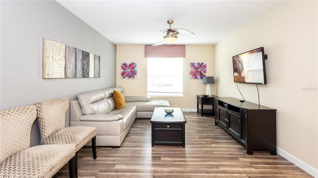 2977 Buccaneer Palm Road Kissimmee, FL 34747 - Photo 20 of 66 a living room with furniture and a flat screen tv
