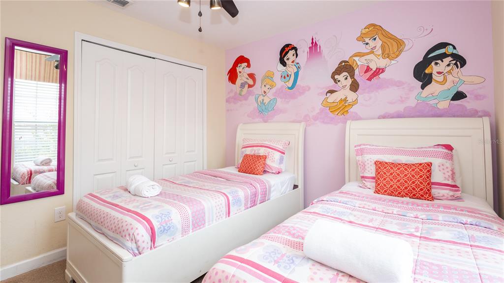 2977 Buccaneer Palm Road Kissimmee, FL 34747 - Photo 23 of 66 a bedroom with a bed and a painting on the wall