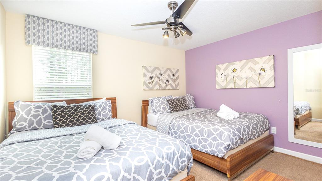 2977 Buccaneer Palm Road Kissimmee, FL 34747 - Photo 31 of 66 a bedroom with two beds and a table