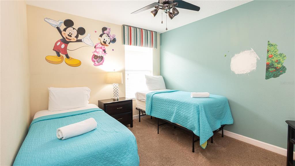 2977 Buccaneer Palm Road Kissimmee, FL 34747 - Photo 37 of 66 a bedroom with a bed and a chandelier