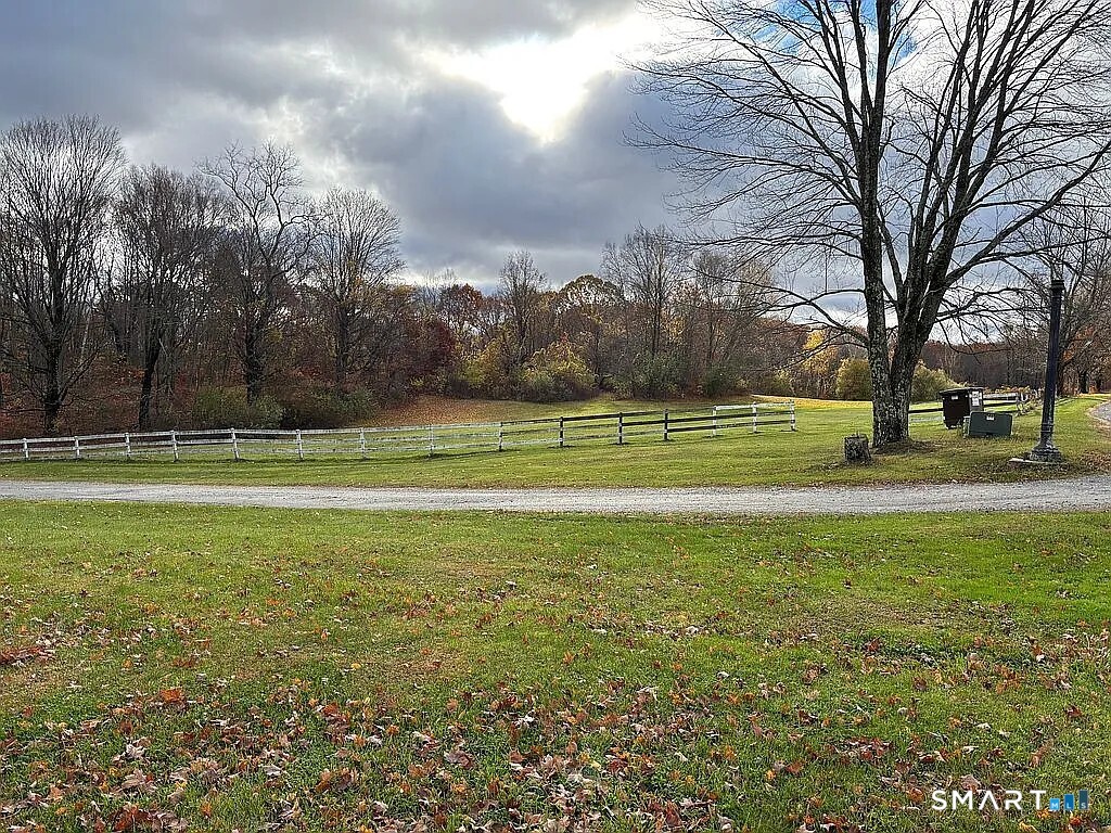 a view of a tennis ground with large trees