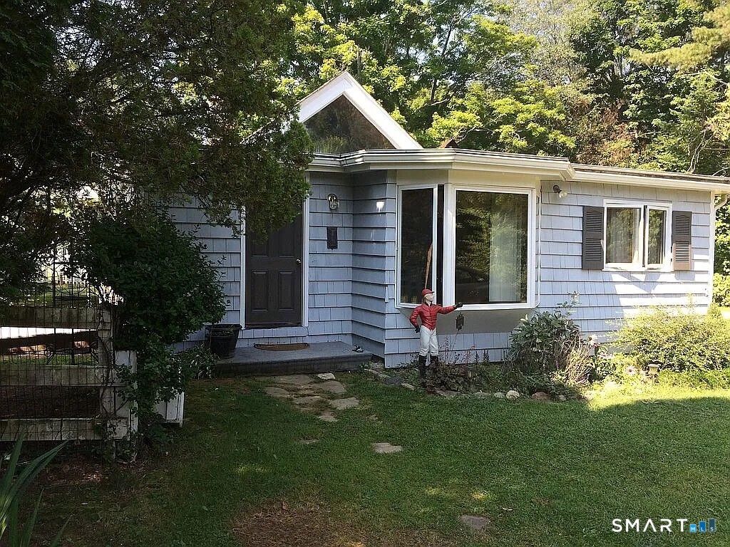 2581 Litchfield Road Watertown, CT 06795 - Photo 14 of 26 a front view of a house with a yard and outdoor seating