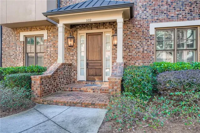 front view of a brick house with a large windows