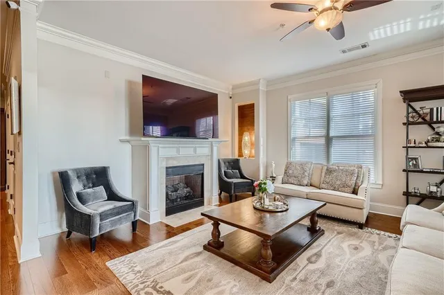 a living room with furniture a flat screen tv and a fireplace