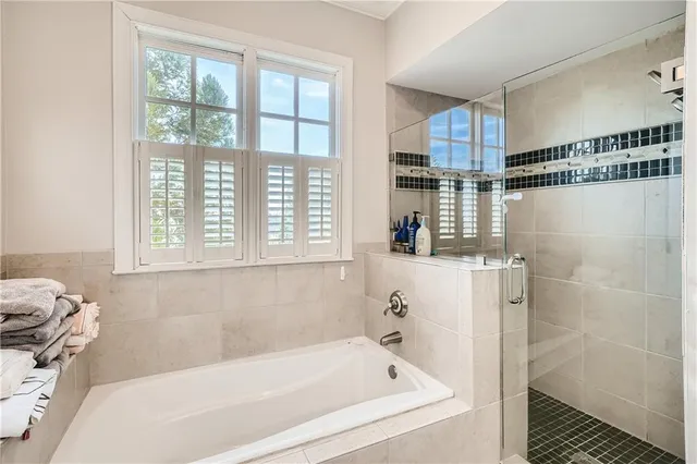 a white bath tub sitting next to a window