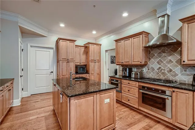 a kitchen with granite countertop a sink stove and refrigerator