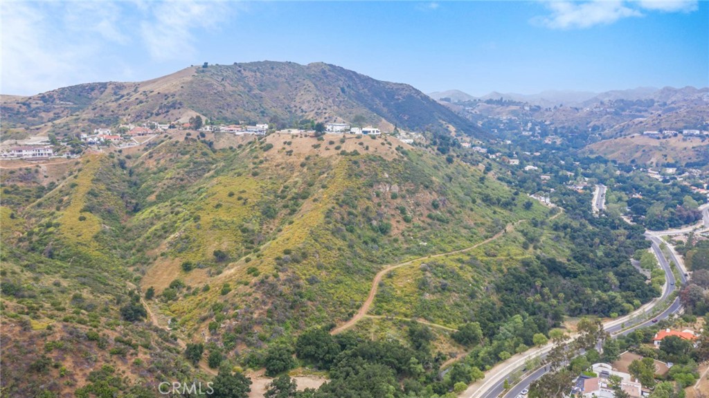 103 Flintlock Lane Bell Canyon, CA 91307 - Photo 13 of 18 a view of a dry yard with mountains in the background