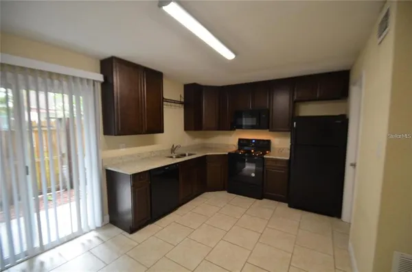 a kitchen with a refrigerator and a sink