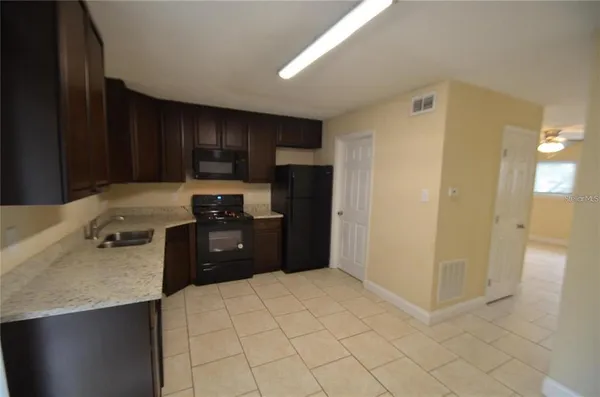 a kitchen with a refrigerator stove and a sink