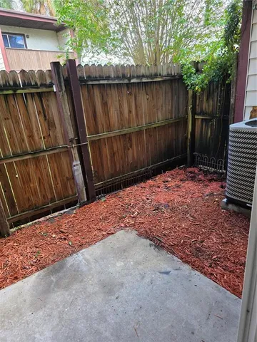 a backyard of a house with wooden fence
