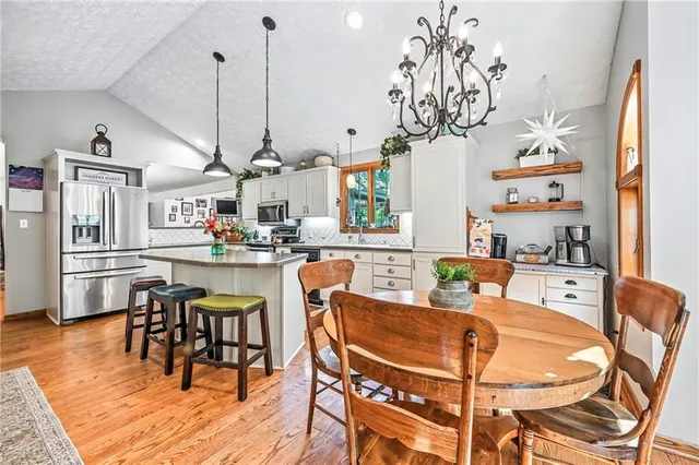 a dining room filled with lots of furniture and wooden floor
