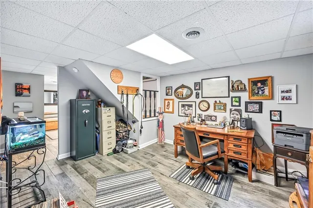 a view of a livingroom with furniture and a book shelf