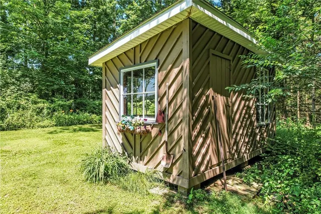 a bed sitting in a bedroom next to a window