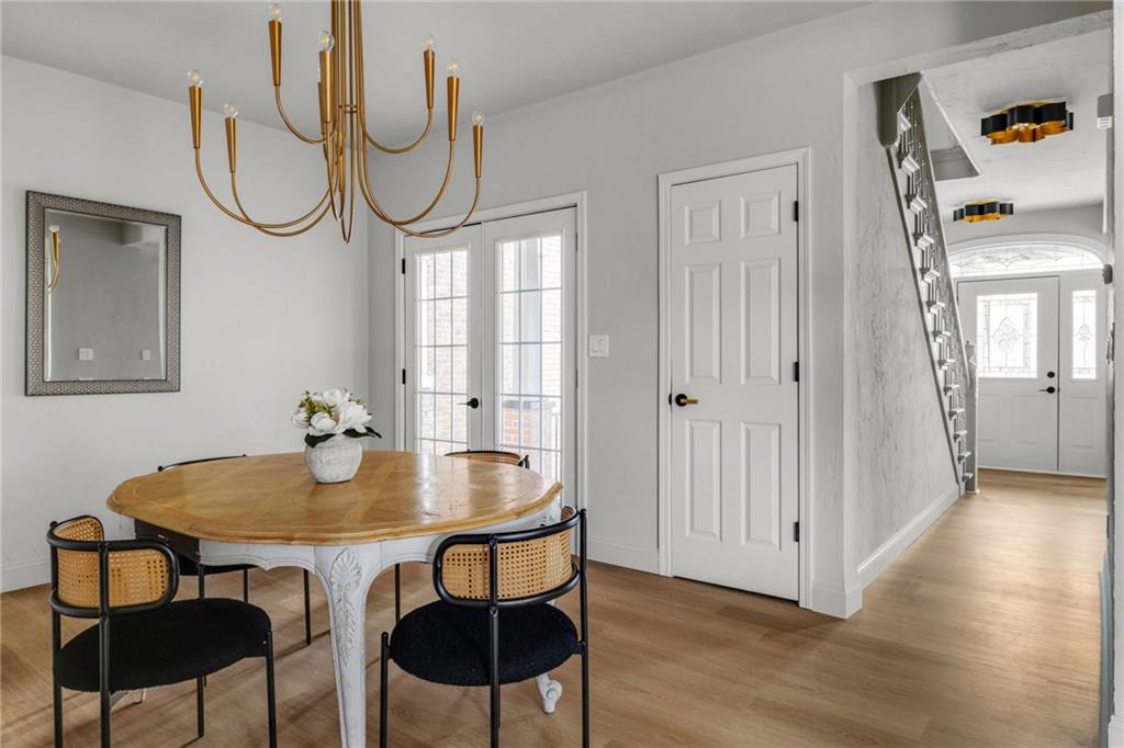 322 East Main Street Ligonier, PA 15658 - Photo 9 of 29 a dining room with wooden floor a glass table and chairs