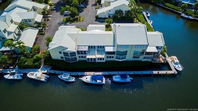 an aerial view of a house with swimming pool and outdoor seating