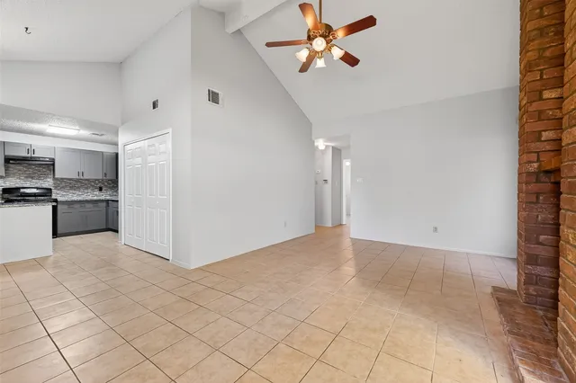 a view of a kitchen with furniture and a ceiling fan