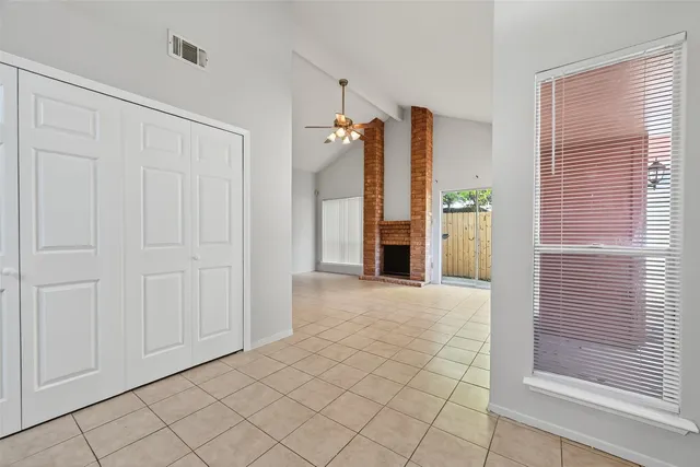 a view of an empty room with window and stairs
