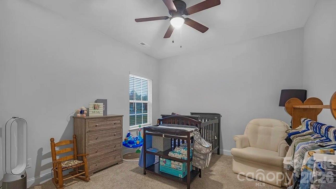 144 Sugar Hill Road Troutman, NC 28166 - Photo 12 of 18 a bedroom with furniture and a gym cycle