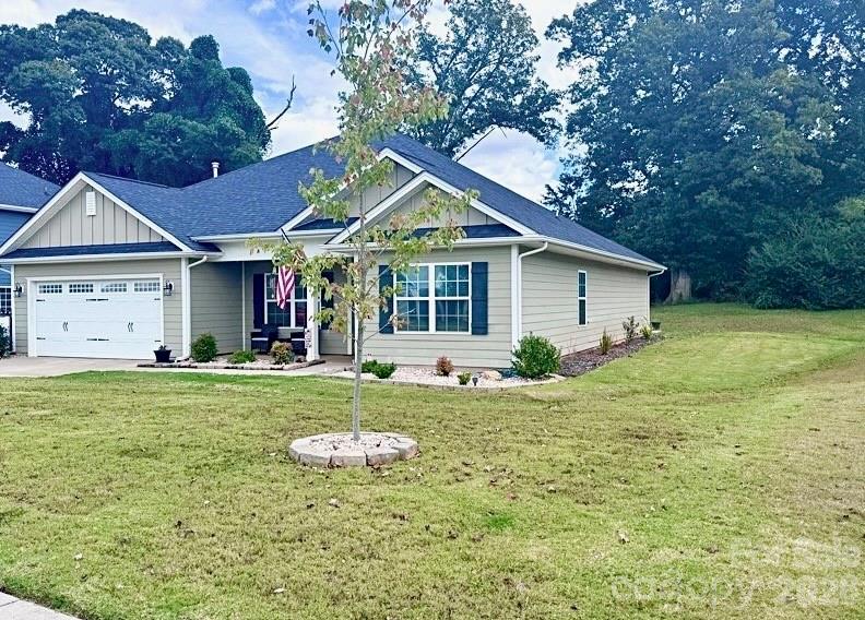 144 Sugar Hill Road Troutman, NC 28166 - Photo 2 of 18 a view of a house with a yard and sitting area