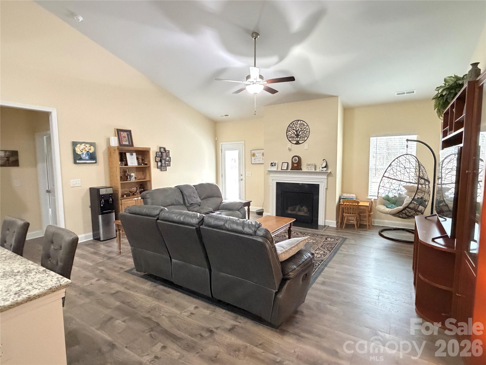 144 Sugar Hill Road Troutman, NC 28166 - Photo 7 of 18 a living room with furniture a fireplace and a flat screen tv
