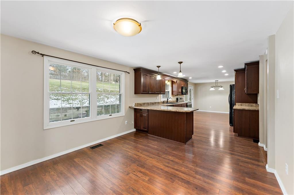 1523 Hastings Mill Road Pittsburgh, PA 15241 - Photo 14 of 50 a large kitchen with stainless steel appliances kitchen island a large counter top and wooden floors