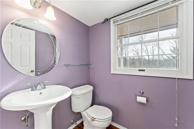 a bathroom with a sink mirror and toilet