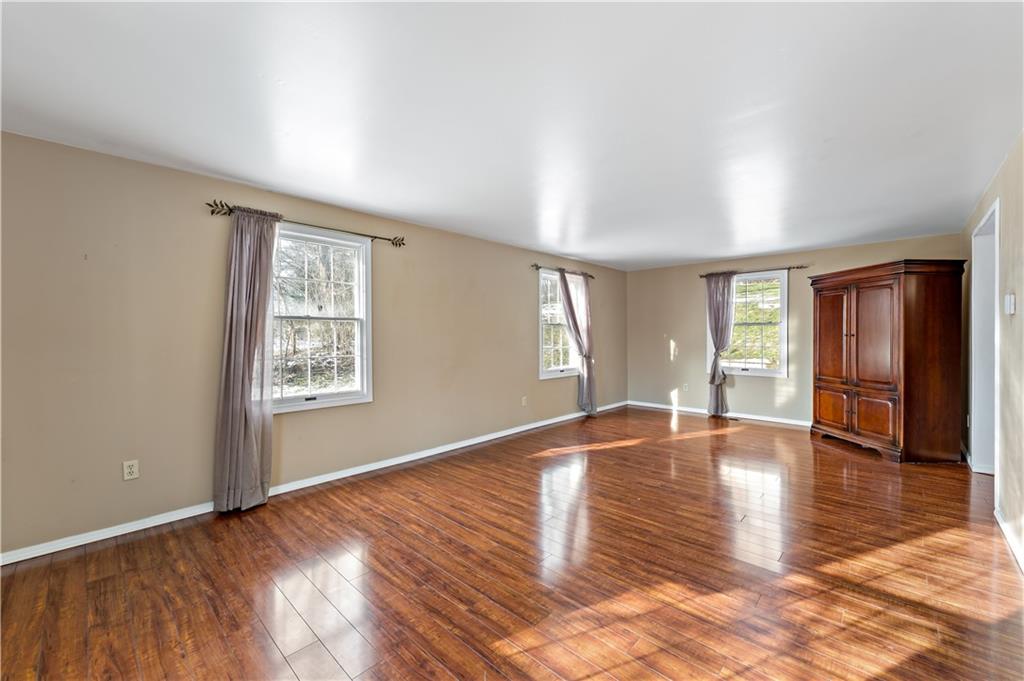 1523 Hastings Mill Road Pittsburgh, PA 15241 - Photo 8 of 50 an empty room with wooden floor and windows