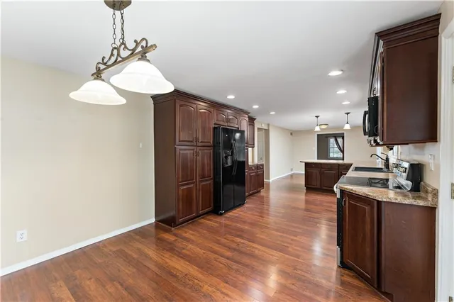 a kitchen with stainless steel appliances granite countertop a refrigerator and a sink