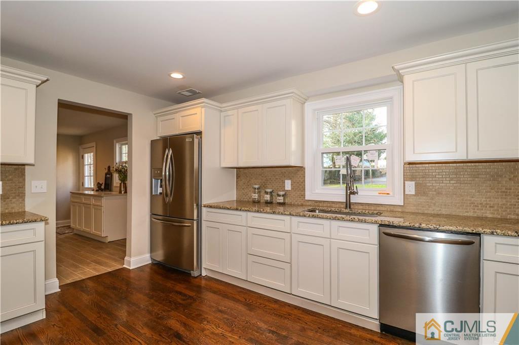 10 Tower Road Edison, NJ 08820 - Photo 22 of 23 a kitchen with a sink a refrigerator and wooden floor