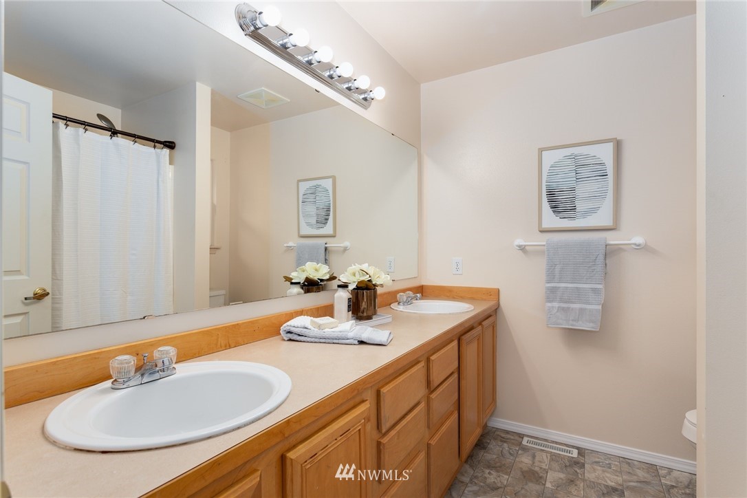 13404 Elk Ridge Road Southeast Monroe, WA 98272 - Photo 22 of 30 a bathroom with a double vanity sink and a mirror