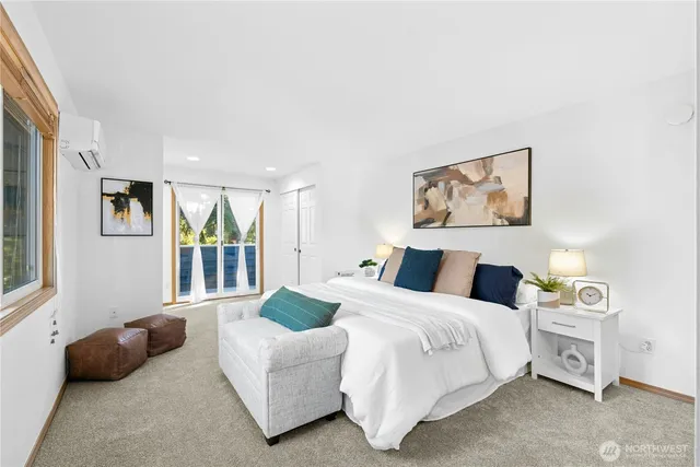 a bedroom with a bed a couch and a window