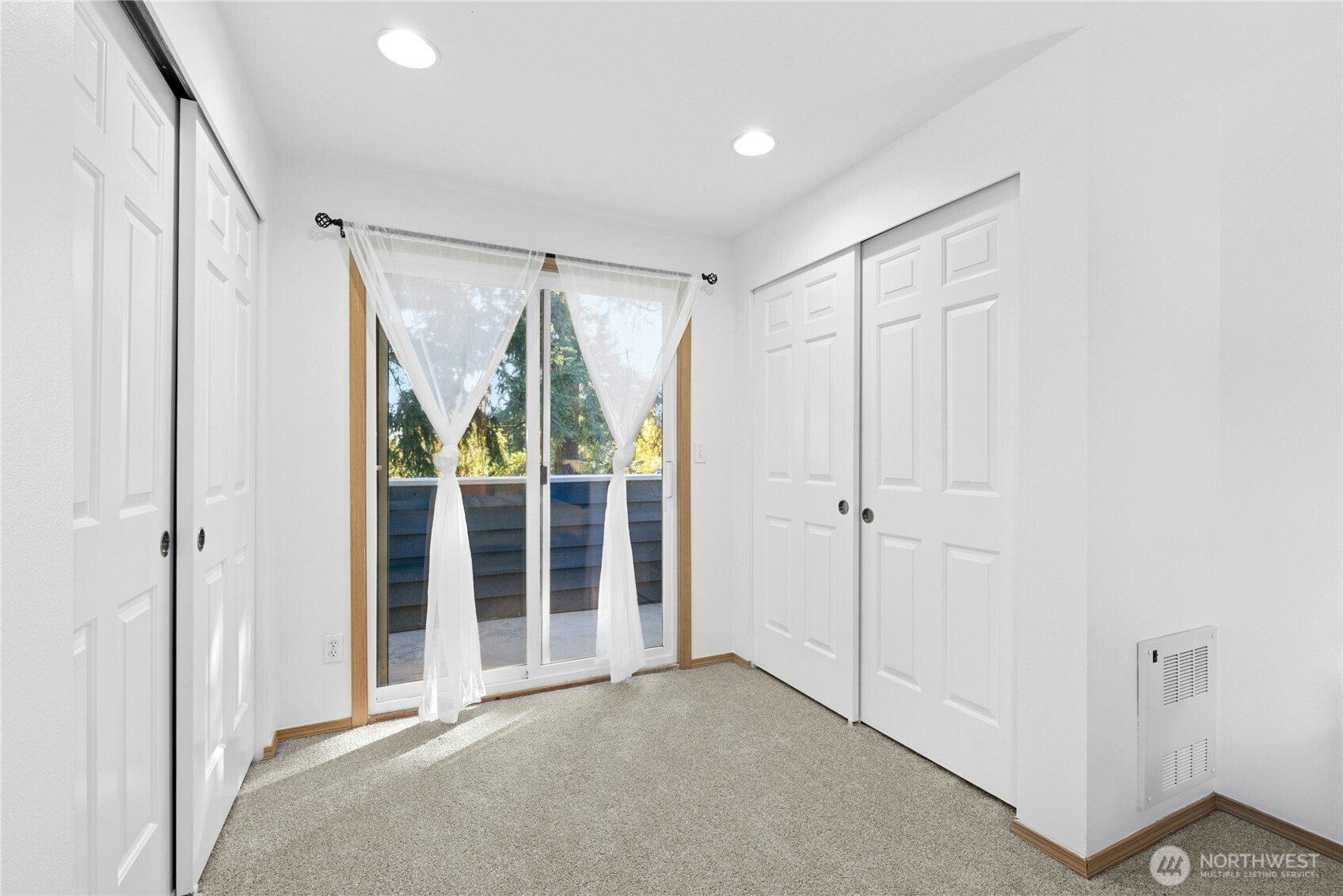 14348 Wallingford Avenue North Seattle, WA 98133 - Photo 19 of 28 a view of an empty room with a sliding door