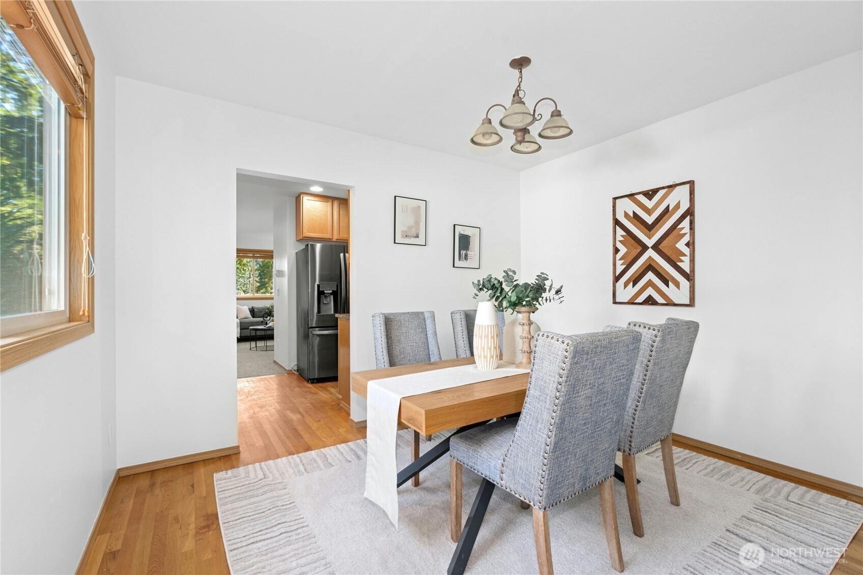 14348 Wallingford Avenue North Seattle, WA 98133 - Photo 6 of 28 a view of a dining room with furniture and wooden floor